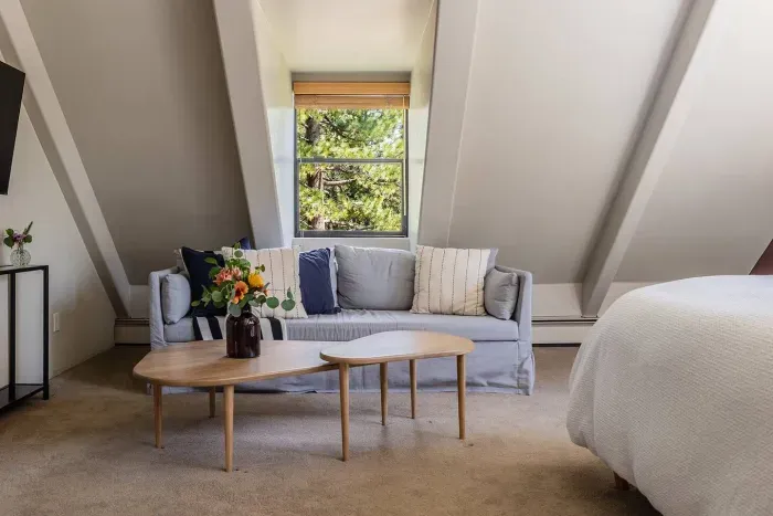 The seating area in the primary bedroom-this sofa has a pull out trundle, and during warmer months we install a window unit AC to keep it cool and comfortable. 