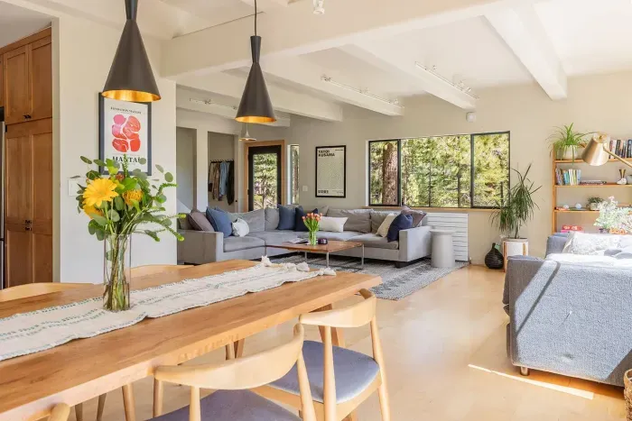 View from the dining room facing the living room. Our dining room has room for 6 plus an adjustable high chair, and our living room has a ton of comfortable seating plus books and games for all age levels. 