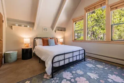 Our flexible room features a queen bed, kids reading nook, plenty of books & toys for the little ones, and views towards the forest and granite boulders. For warmer months, a window AC unit keeps this room cool and comfortable.