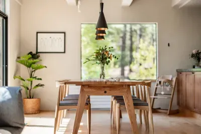 The dining room with forest views, plenty of seating for 6 and high chair available for your use. Easy access to both the back deck and the kitchen!