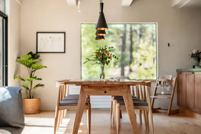 The dining room with forest views, plenty of seating for 6 and high chair available for your use. Easy access to both the back deck and the kitchen! 