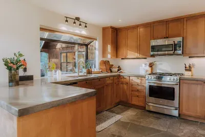 Our kitchen features a gas stove, built in microwave, dishwasher and large refrigerator. We've stocked it with plenty of small appliances, quality cookware, spices +oils and everything you'd need to cook a great meal!  Photography by @dirtandglass