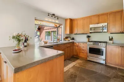 Our kitchen features a gas stove, built in microwave, dishwasher and large refrigerator. We've stocked it with plenty of small appliances, quality cookware, spices +oils and most everything you'd need to cook a great meal.