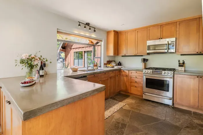 Our kitchen features a gas stove, built in microwave, dishwasher and large refrigerator. We've stocked it with plenty of small appliances, quality cookware, spices +oils and most everything you'd need to cook a great meal. 