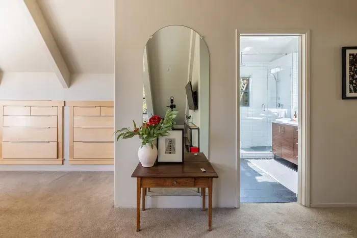 Entrance to the upstairs ensuite bath. Built in dressers are just to the left, and the flexible kids room is just a few steps to the right across a stairwell landing for easy access. 