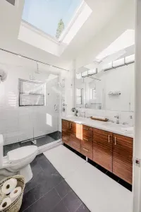 The primary ensuite bath is located on the second level. Large walk in shower with dual shower heads, double vanity and extra large skylight. We provide Sparta Candle co lotions and soaps as a special treat for you. 

photography by @dirtandglass
