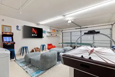 Cool garage game room with air conditioning, ping pong, air hockey, and classic arcade fun.