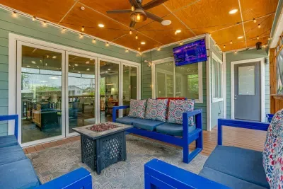 Step out onto the expansive covered patio featuring a 65-inch HDTV.