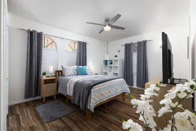 Queen size bed with private bathroom that includes full shower. 