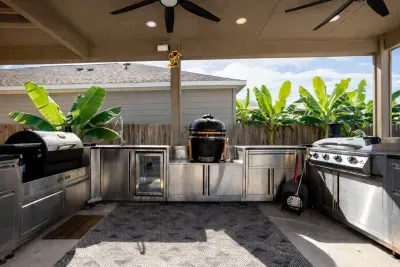 Outdoor kitchen with gas, charcoal, pellet grills & pizza oven.