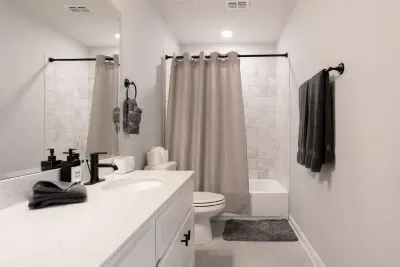 Shared bathroom with shower-tub combo.