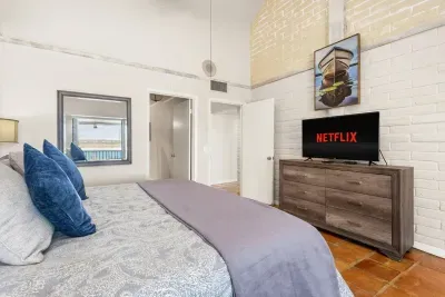 The bedroom includes a comfortable setup with a TV, perfect for unwinding with your favorite shows after a day at the lake.