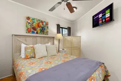 This inviting bedroom offers a restful space complete with a TV, great for cozy evenings and a bit of downtime after your lake adventures.