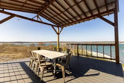 A cozy open-air dining area with a table and chairs, ideal for intimate outdoor meals while enjoying peaceful lake views.