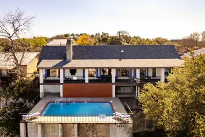 An aerial view showcasing the house, pool, and lake, highlighting the property's beautiful layout and scenic surroundings.