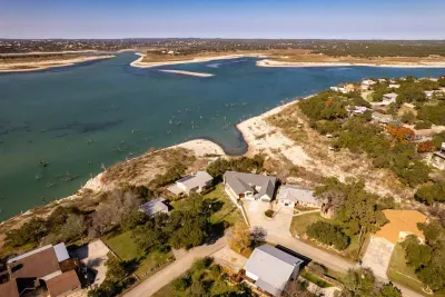 An aerial view showcasing the house, pool, and lake, highlighting the property's beautiful layout and scenic surroundings.