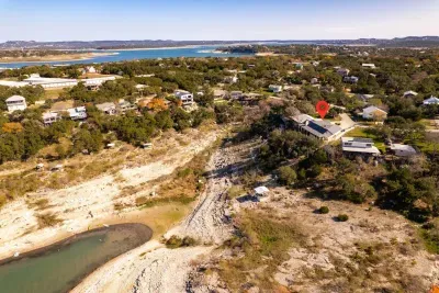 An aerial view showcasing the house, pool, and lake, highlighting the property's beautiful layout and scenic surroundings.