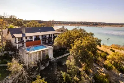 An aerial view showcasing the house, pool, and lake, highlighting the property's beautiful layout and scenic surroundings.