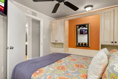 This inviting bedroom offers a restful space complete with a TV, great for cozy evenings and a bit of downtime after your lake adventures.