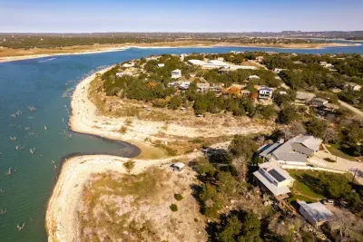 An aerial view showcasing the house, pool, and lake, highlighting the property's beautiful layout and scenic surroundings.