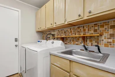 A dedicated laundry area equipped with a washer and dryer for convenient, hassle-free washing during your stay.