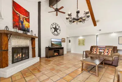 Cozy up by the fireplace and enjoy your favorite shows on TV, perfect for movie nights in the comfort of the spacious living room.