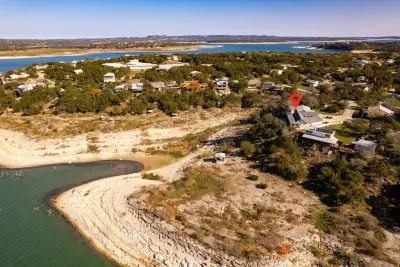 An aerial view showcasing the house, pool, and lake, highlighting the property's beautiful layout and scenic surroundings.