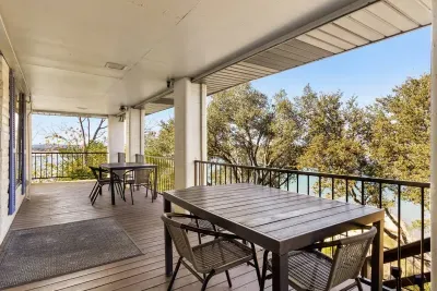 The patio features two dining tables along the hallway, perfect for enjoying meals outdoors with views of the surrounding scenery.