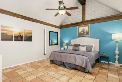 This cozy bedroom offers a welcoming atmosphere with soft lighting and comfortable bedding, perfect for restful nights and laid-back mornings.