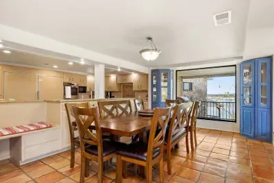 The dining area, located just steps from the kitchen counter, offers a convenient and inviting space for meals and gatherings.