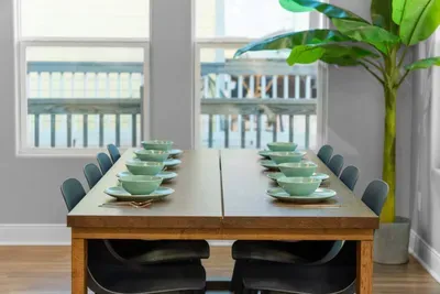 A bright dining space set for the whole crew—perfect for family dinners, game nights, and making memories after a day at the beach.