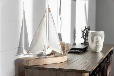 Coastal touches throughout the home add to the relaxed beach vibe, with nautical decor and simple details that make the space feel warm and inviting.