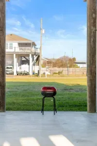 Charcoal grill ready for your beach getaway—perfect for easy cookouts after a day in the sun. Enjoy the open yard space, coastal breeze, and plenty of room to unwind while dinner is on the grill.