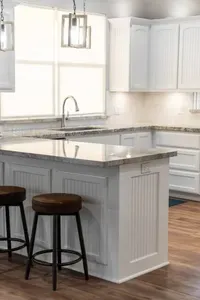 Bright, open kitchen with a large island and bar seating—perfect for quick breakfasts, meal prep, and gathering with family and friends.