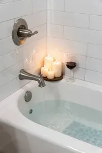 Unwind in the tub after a beach day with a relaxing soak in this bright, spa-like bathroom featuring a clean tiled surround and a comfortable space to recharge.