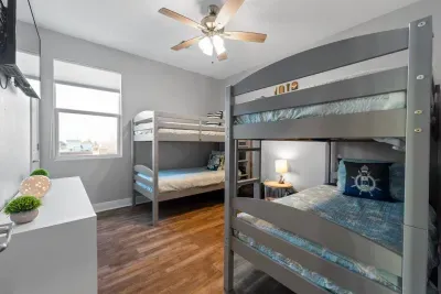 Perfect for kids or extra guests, this bunk room is bright, fun, and comfortable with plenty of space to spread out after a day at the beach.