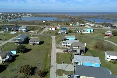 Aerial views of the Crystal Beach area with wide-open space, coastal scenery, and quick access to both the beach and nearby bay-side adventures.