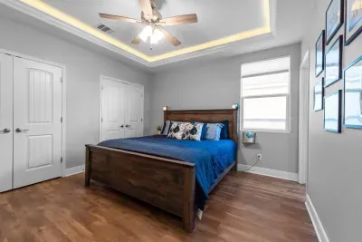Relax and recharge in the spacious primary bedroom with a comfortable king bed, soft lighting, and a calm coastal feel.