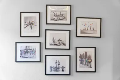 A bright coastal gallery wall that adds character to the space, featuring curated beach-inspired prints and clean modern frames for a polished, relaxed feel.