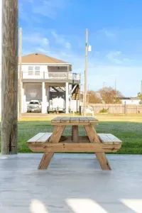 Relax outside and enjoy the coastal breeze with a picnic table on the covered patio—perfect for morning coffee, family meals, or winding down after a day at the beach. Plenty of space to spread out and enjoy the fresh air.
