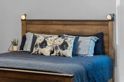 Unwind in the primary suite featuring a spacious king bed, cozy bedding, and a relaxing coastal feel—your perfect retreat after a day at the beach.