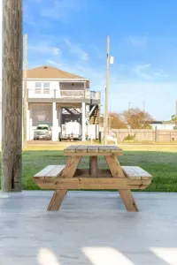 Relax outside and enjoy the coastal breeze with a picnic table on the covered patio—perfect for morning coffee, family meals, or winding down after a day at the beach. Plenty of space to spread out and enjoy the fresh air.