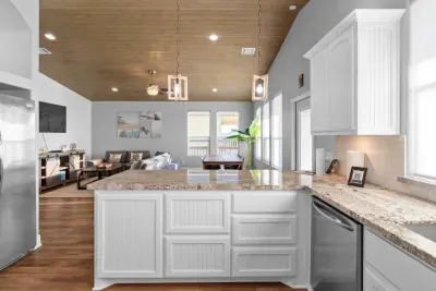 Bright, open-concept kitchen with plenty of counter space—perfect for cooking, gathering, and staying connected with everyone in the living room.