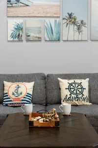 Unwind in the bright, coastal-style living room—stretch out on the comfy sectional, sip your morning coffee, and relax after a day at the beach.