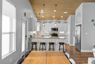 Open-concept layout with a spacious kitchen, large island seating, and plenty of room for everyone to gather, eat, and relax together.