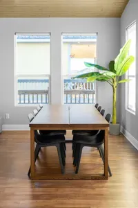 A bright, open dining area with plenty of seating—perfect for family meals, game nights, and planning your next beach day.