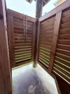 Enjoy a private outdoor shower tucked into a fully enclosed cedar space. Open-air above for a fresh coastal feel, with plenty of privacy and a convenient rinse-off area—perfect after the beach.