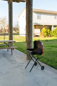 Fire up the charcoal grill and enjoy an easy outdoor meal right at home. The covered patio gives you plenty of space to cook, gather, and relax, with a picnic table nearby for casual lunches, family dinners, or post-beach snacks.