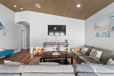 Cozy living room setup with plenty of seating, a big TV for movie nights, and an open layout that keeps everyone together.