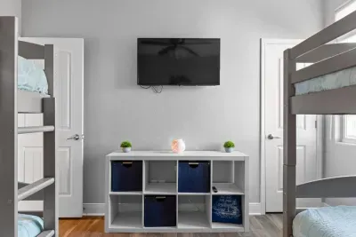 Perfect hangout spot for the kids! This bunk room includes a wall-mounted TV and a cubby storage center to keep games, toys, and luggage organized—so everyone can unwind, spread out, and enjoy their own space after a fun day at the beach.